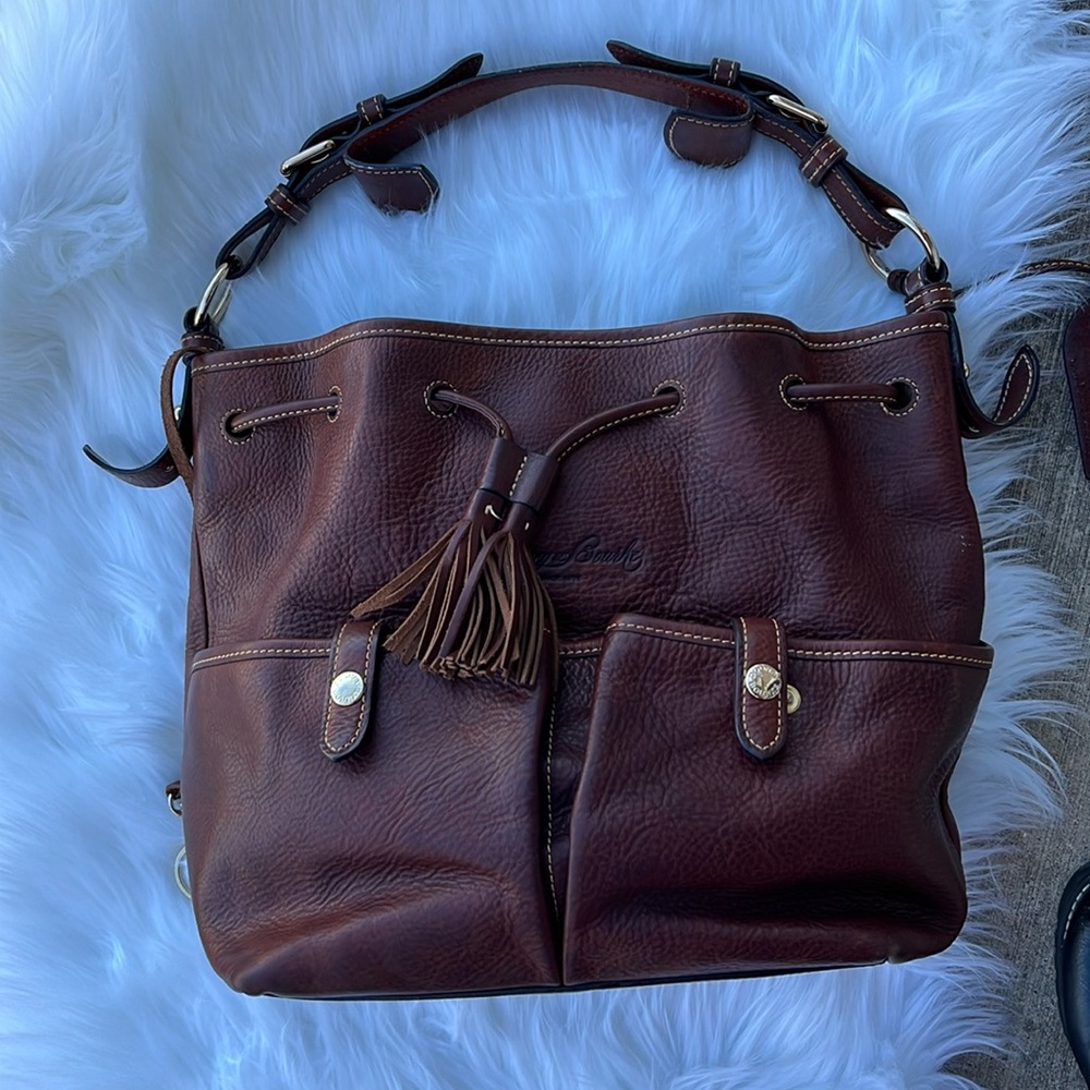 Dooney & Bourke Brown Leather  
purse is pebbled leather absolutely gorgeous.